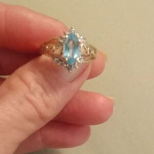 Avon 10 k natural ice blue topaz and diamond ring. Size 7.75